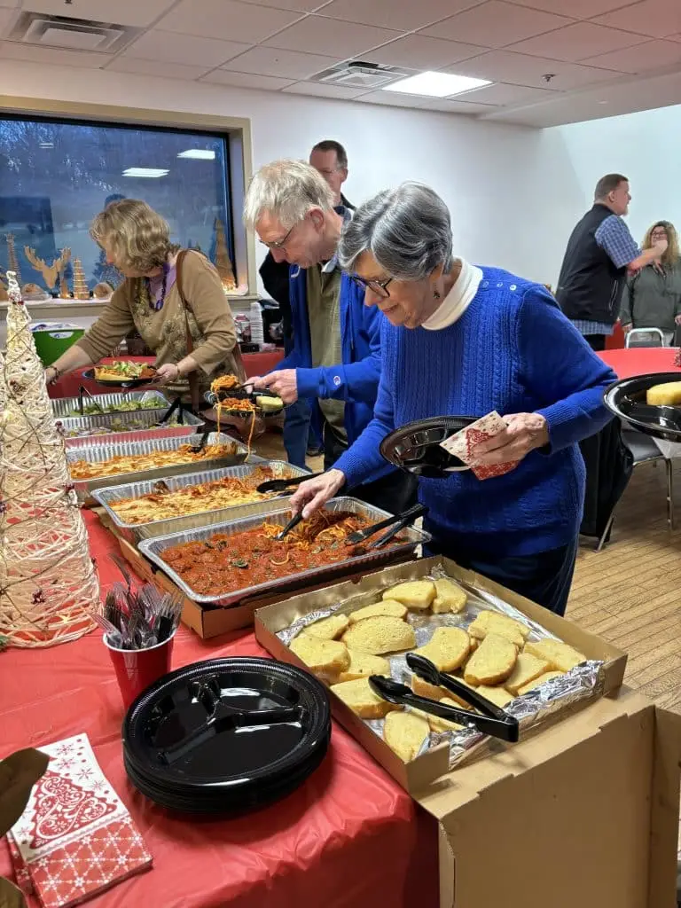Deaf Ministry members gathering food during a potluck